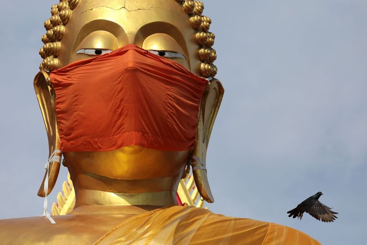 Buddha statue wearing a face mask